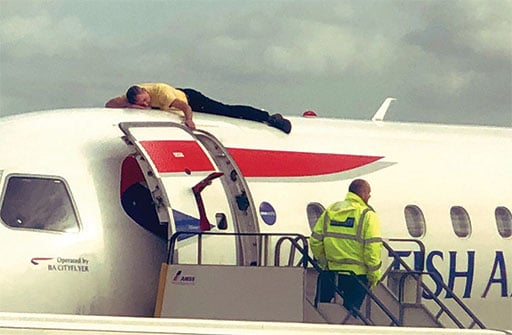 Paralympian James Brown on top of a British Airways plane during an  Extinction Rebellion protest at London City Airport (Credit: Twitter/Jonmew)