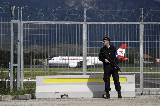 An Albanian military policeman stands guard outside Mother Teresa International Airport in Tirana on 11 April 2019