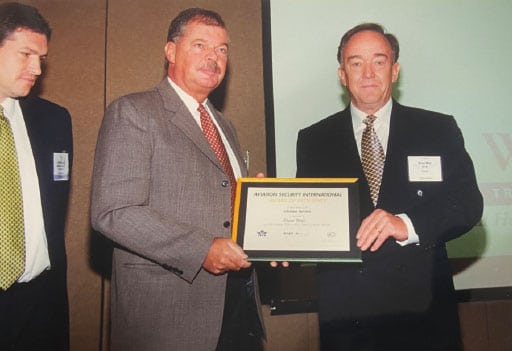 Brian Wall receives his lifetime award for service to the aviation security community from Werner Schaub and Philip Baum at AVSEC World 2000