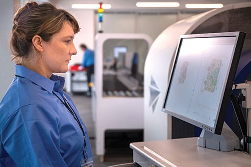 The Leidos ClearScan is part of a comprehensive aviation checkpoint solution that includes tray return systems, people screening, explosives trace and security management software. Leidos image. This total solution improves threat detection, enhances traveler satisfaction, and increases operational efficiency. xx